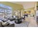 Bright, open living room with large windows, tile flooring, and a view into the dining area at 9742 E Hawaii Pl, Aurora, CO 80247