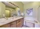 Bright main bathroom with double vanity, soaking tub, and updated fixtures at 9742 E Hawaii Pl, Aurora, CO 80247