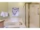 Main bathroom featuring a soaking tub with shower, and decorative wall art at 9742 E Hawaii Pl, Aurora, CO 80247