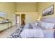 View of bright main bedroom with vaulted ceiling, patterned rug, and ensuite bathroom access at 9742 E Hawaii Pl, Aurora, CO 80247