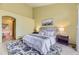 A view of the bright main bedroom with ensuite bathroom access and patterned rug at 9742 E Hawaii Pl, Aurora, CO 80247