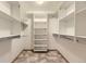 Walk-in closet with built-in shelving and hanging rods for maximum storage at 9742 E Hawaii Pl, Aurora, CO 80247