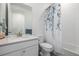 Bathroom featuring single vanity, toilet, and shower-tub combo with a pretty shower curtain at 15979 Xanthia Way, Thornton, CO 80602