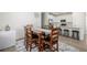Bright dining room leading into kitchen with ample seating and natural light from the large windows at 15979 Xanthia Way, Thornton, CO 80602
