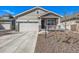 Charming one-story home featuring stone accents, neutral siding, a front porch, a well-maintained lawn, and an attached garage at 15979 Xanthia Way, Thornton, CO 80602