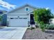 Charming single-Gathering home featuring a manicured front yard, covered porch, and a two-car garage at 15979 Xanthia Way, Thornton, CO 80602