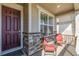 Inviting front porch with stone accents, decorative lattice, and comfortable seating for relaxing outdoors at 15979 Xanthia Way, Thornton, CO 80602