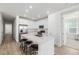 Bright eat-in kitchen with stainless steel appliances and an island with stool seating at 15979 Xanthia Way, Thornton, CO 80602