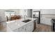 Gourmet kitchen features stainless appliances and a large center island with sink at 15979 Xanthia Way, Thornton, CO 80602