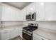 Stylish kitchen with white cabinetry, stainless appliances, and modern gas range at 15979 Xanthia Way, Thornton, CO 80602
