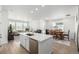 Open kitchen features large island and opens to the living and dining areas at 15979 Xanthia Way, Thornton, CO 80602
