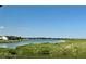 Scenic lake view with lush greenery, golf course, and neighboring homes at 15979 Xanthia Way, Thornton, CO 80602