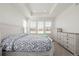 Inviting main bedroom features tray ceiling, natural light, and dresser set at 15979 Xanthia Way, Thornton, CO 80602