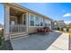 Back patio with outdoor seating and grill at 15979 Xanthia Way, Thornton, CO 80602