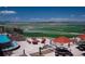 Enjoy a beautiful view while relaxing by the pool with a fire pit and comfortable seating area at 15979 Xanthia Way, Thornton, CO 80602