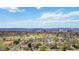 Gorgeous aerial view of neighborhood with recreational facilities, trees, and distant mountain views at 1050 S Monaco Pkwy # 42, Denver, CO 80224