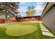 Expansive backyard features a putting green, gazebo, and lush lawn at 9380 W 51St Ave, Arvada, CO 80002