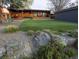 Backyard featuring a putting green, lush landscaping, and a charming single-story home at 9380 W 51St Ave, Arvada, CO 80002
