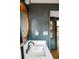 Stylish bathroom showcasing a custom mirror, modern fixtures, and sleek floating vanity with neutral accents at 9380 W 51St Ave, Arvada, CO 80002