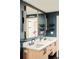 Stunning bathroom features dual sinks, modern fixtures, sleek cabinets, and elegant gold trimmed mirrors at 9380 W 51St Ave, Arvada, CO 80002