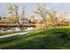 Picturesque view of a tranquil lake with a walking path and lush green surroundings at 9380 W 51St Ave, Arvada, CO 80002