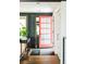 Stylish entryway with hardwood floors, a red door, and modern decor at 9380 W 51St Ave, Arvada, CO 80002