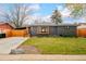 Charming single-story home with a well-maintained lawn and a modern gray brick exterior at 9380 W 51St Ave, Arvada, CO 80002