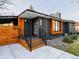Modern exterior featuring a gray brick facade, wooden accents, and a vibrant red door at 9380 W 51St Ave, Arvada, CO 80002
