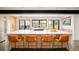 Bright kitchen island with seating, integrated cooktop, and views of outdoor landscaping at 9380 W 51St Ave, Arvada, CO 80002