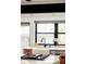 Bright kitchen sink beneath window complemented by modern fixtures and finishes at 9380 W 51St Ave, Arvada, CO 80002