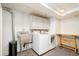Functional laundry room with modern washer, dryer, and utility sink at 9380 W 51St Ave, Arvada, CO 80002