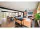 Open concept living room featuring hardwood floors, a fireplace, and a dining area at 9380 W 51St Ave, Arvada, CO 80002