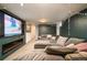 Basement Living Room with big sofa and fireplace with modern finishes creates a cozy vibe at 9380 W 51St Ave, Arvada, CO 80002
