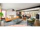 Spacious living room with hardwood floors, modern furniture, and an open floor plan at 9380 W 51St Ave, Arvada, CO 80002