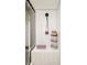 Tiled shower with a shower head and a convenient seat, complemented by open storage for toiletries at 9380 W 51St Ave, Arvada, CO 80002