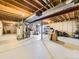 Unfinished basement with exposed beams and concrete floor, offering potential for customization and expansion at 3210 S Espana Cir, Aurora, CO 80013