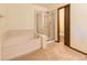 Bathroom with a large tub and a separate glass-enclosed shower at 3210 S Espana Cir, Aurora, CO 80013
