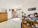 Bright bedroom featuring a wood bed frame, a fluffy rug, and a window at 3210 S Espana Cir, Aurora, CO 80013