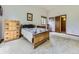 Traditional bedroom with a decorative wooden bed frame and chest of drawers on neutral carpeting at 3210 S Espana Cir, Aurora, CO 80013