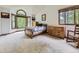 Spacious bedroom with large windows, vaulted ceilings, and neutral carpet at 3210 S Espana Cir, Aurora, CO 80013