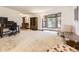 Spacious living room with a large bay window, wooden accents, and neutral carpet throughout at 3210 S Espana Cir, Aurora, CO 80013