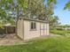 Outdoor storage shed with double doors and a window, offering ample space for tools and equipment at 3210 S Espana Cir, Aurora, CO 80013