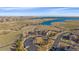 Aerial view of the community with recreational facilities and walking trails by a beautiful lake and natural landscape at 27185 E Costilla Dr, Aurora, CO 80016