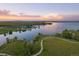 Beautiful sunset aerial view featuring a lakeside community with walking trails at 27185 E Costilla Dr, Aurora, CO 80016