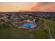 Sunset aerial shot of the community pool and clubhouse in a large neighborhood at 27185 E Costilla Dr, Aurora, CO 80016