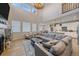 Open-concept living area flowing into a modern kitchen, with ample natural light and a comfortable sectional sofa at 27185 E Costilla Dr, Aurora, CO 80016