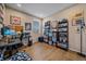 Functional home office with hardwood floors, ample shelving, and a bright window at 27185 E Costilla Dr, Aurora, CO 80016