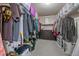 Spacious walk-in closet featuring built-in shelving and ample storage for clothing at 27185 E Costilla Dr, Aurora, CO 80016