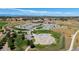 Aerial view showcases the skate park, school, and surrounding landscape at 13734 Ash Cir, Brighton, CO 80602