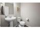 Clean half bathroom with pedestal sink and modern fixtures at 13734 Ash Cir, Brighton, CO 80602